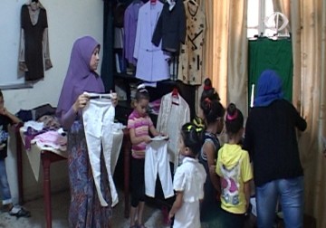 جمعية هنا التربوية الإجتماعية توزع كسوة العيد قبل حلول عيد الفطر المبارك  - 15 – 7 – 2015 - مريم الحاج موسى